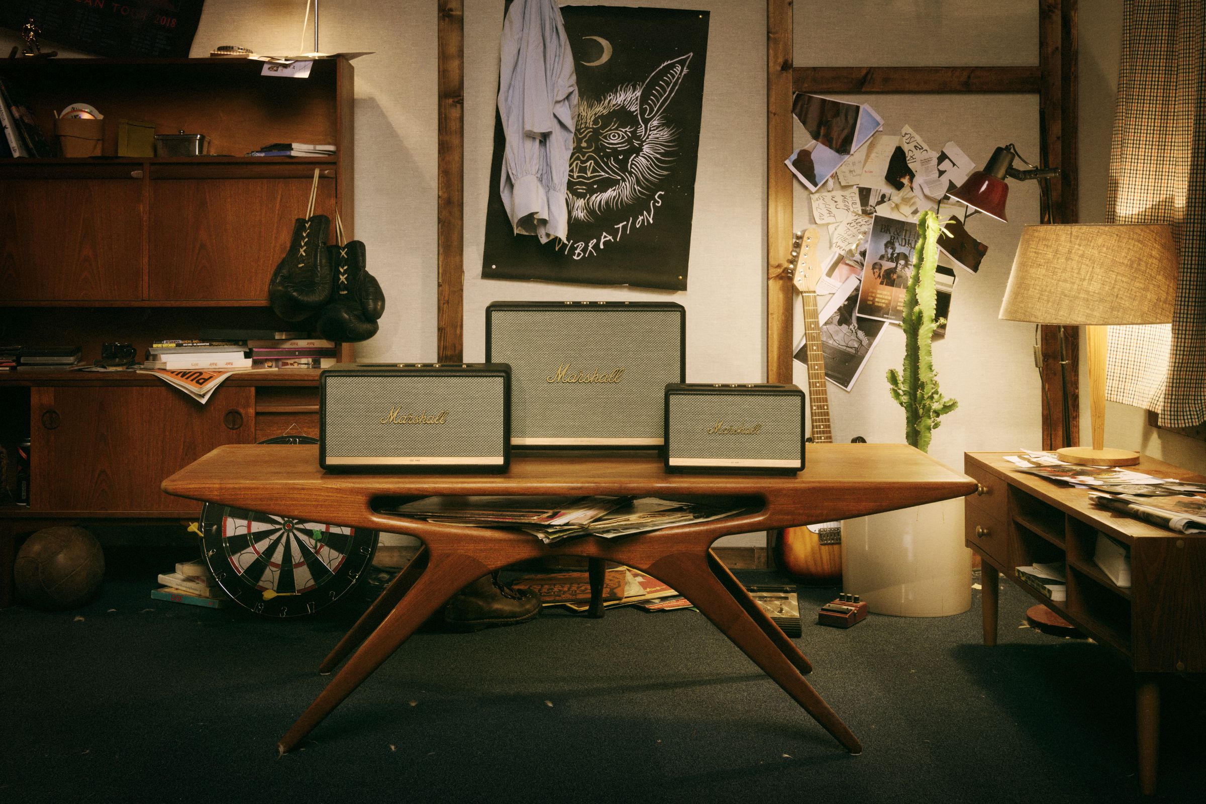 Three Marshall-branded speakers sit on a table.